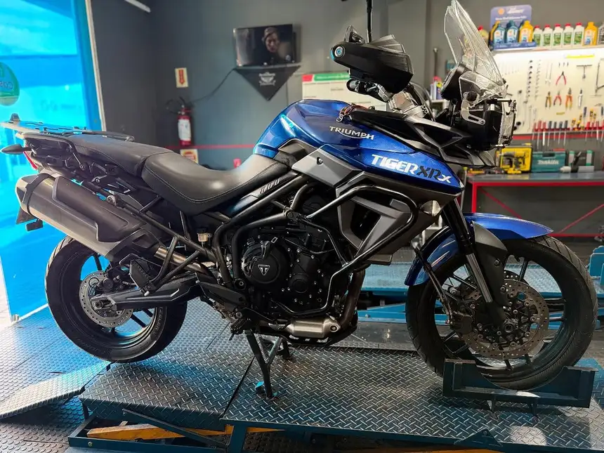 Triumph Tiger 800 azul no elevador da oficina